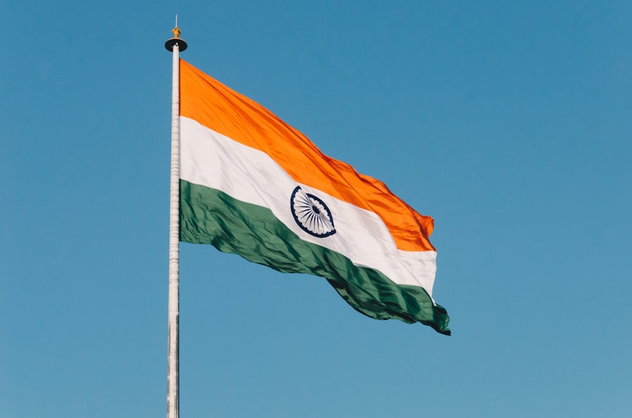 The Indian national flag flying against a blue sky.