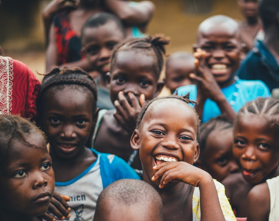 Smiling children in a rural village setting, representative of the Rural Orphan Children Program.