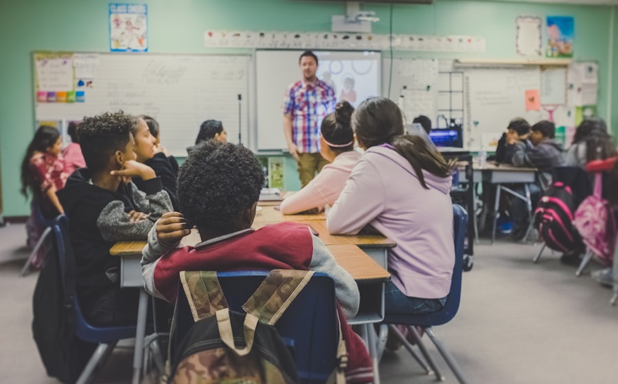 A teacher standing with students seated in rows at their desks.